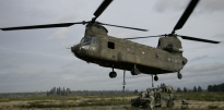 Soldiers attaching a Humvee to a Chinook helicopter Soldiers attaching a Humvee to a Chinook helicopter