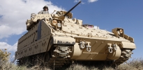 M2/M3 Bradley Fighting Vehicle (BFV) coming over a hill M2/M3 Bradley Fighting Vehicle (BFV) coming over a hill