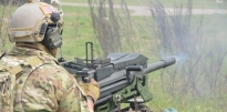 Soldier firing a MK19 Grenade Launcher Soldier firing a MK19 Grenade Launcher