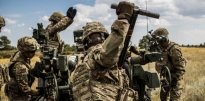 Soldiers conducting training in a field. 
