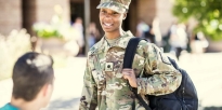 Cadet talking to a student outside of college campus.