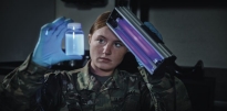 Soldier wearing OCP inside of medical facility holding a black light and a jar.