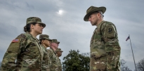 U.S. Army Drill Sergeant inspecting soldiers in a formation. 