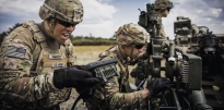 Soldiers wearing OCP and helmets taking part in Field Training.