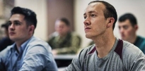 Cadets sitting inside a classroom.